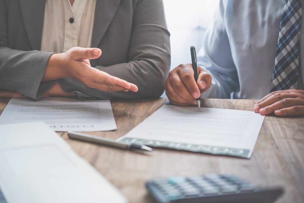 businessman is negotiating, advising, and explaining the matter of the contract to be agreed to sign the contract.